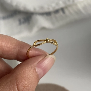 Elegant 925 sterling silver bow ring with gold finish and braided texture