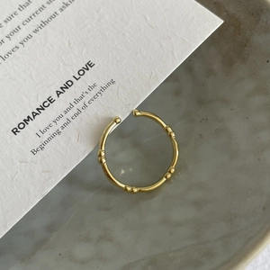 Minimalist gold S925 sterling silver bamboo open ring shown on a white textured card