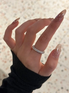 Close-up of 925 sterling silver eternity ring with zircon stones on a model hand