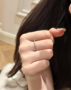 Close-up of eternity ring with pavé sparkling cubic zirconia on a female finger