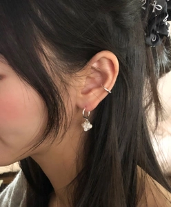 Close-up of S925 sterling silver ear cuffs and earrings set with delicate pearl clusters