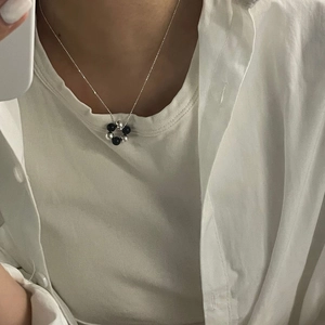 Minimalist S925 sterling silver necklace with black and silver beads on a model