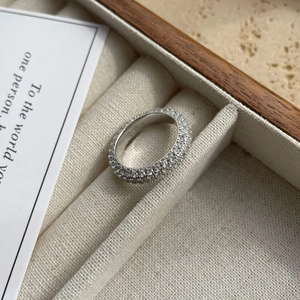 Close-up of a 925 sterling silver ring with three rows of micro-pave cubic zirconia