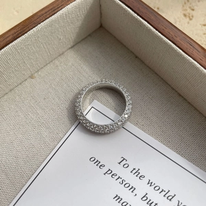 Detailed view of S925 sterling silver stamp on full-pave sparkling zircon band ring