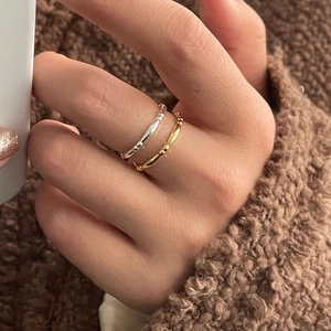 Close-up of minimalist S925 sterling silver oval bamboo rings stacked on fingers