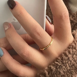 Detailed view of a gold-plated bamboo joint style S925 sterling silver ring on a finger