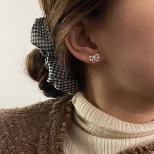 Gros plan de boucles d'oreilles nœud en argent S925 avec zircone sur un mannequin