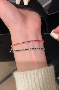 Detail of minimalist S925 sterling silver red and black woven cord bracelets for women