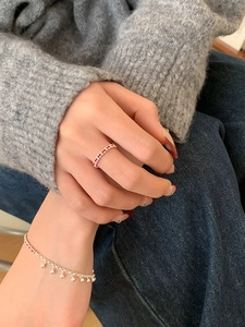 Close-up of S925 sterling silver ring and woven red string bracelet on a model