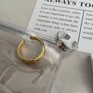 Macro shot of S925 sterling silver stamp on adjustable star texture rings in gold and silver