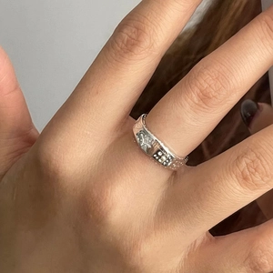 Macro view of 925 sterling silver ring with engraved star patterns and cubic zirconia