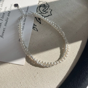 Detail of S925 silver beaded bracelet with pearls and heart pendant extension chain
