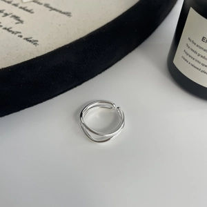 Macro shot of minimalist double-layered silver ring with adjustable open band design