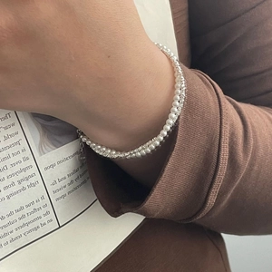 Detail of S925 silver double-layered bracelet with white pearls and silver beads