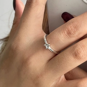 Macro shot of 925 sterling silver star ring with hammer texture on a finger