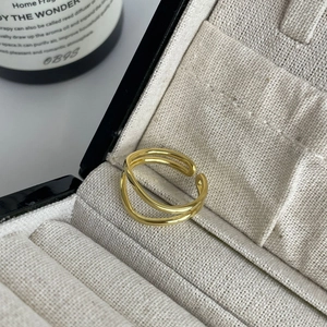 Detailed close-up of S925 sterling silver stamp on golden double layered open ring