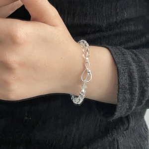 Close-up of S925 silver infinity clasp on a clear crystal beaded bracelet for women