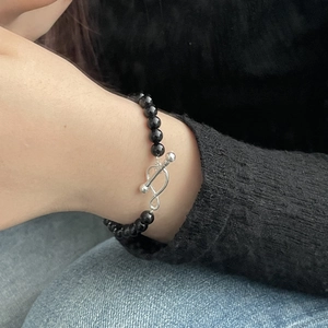 Detail of S925 silver infinity toggle clasp on a beaded black agate bracelet