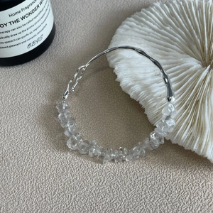 Close-up of S925 sterling silver bracelet with irregular clear quartz crystals on leather