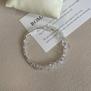 Detail of a 925 silver bracelet featuring clear crystal stones and a polished metal band