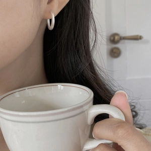 Minimalist S925 sterling silver hoop earring shown on model with a brushed metal finish