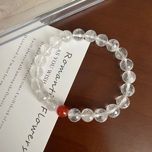 Minimalist faceted white crystal bracelet with a vintage red agate bead on wood
