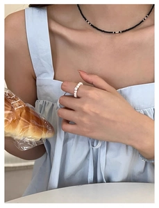 Vue détaillée d'une bague en perles d'argent S925 avec une pierre de cristal blanc au centre