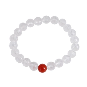 Faceted white crystal beaded bracelet with a single red agate bead on white background