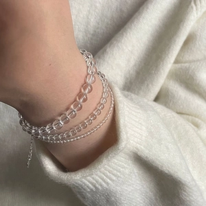 Detail of S925 silver layered bracelet featuring white crystal beads and adjustable chain