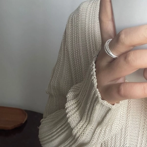 Close-up of minimalist S925 sterling silver multilayer twisted ring on finger