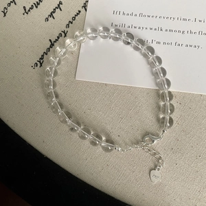Detail of S925 sterling silver lobster clasp and heart tag on white crystal bead bracelet