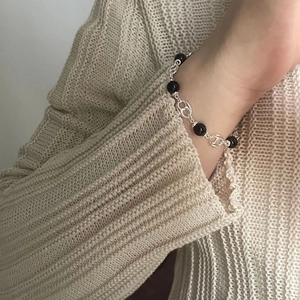 Chic S925 sterling silver beaded bracelet with black agate and pig nose links on a wrist