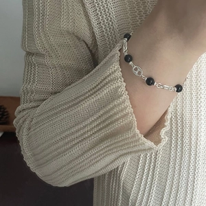Detailed close-up of S925 sterling silver chain bracelet with black agate beads on wrist