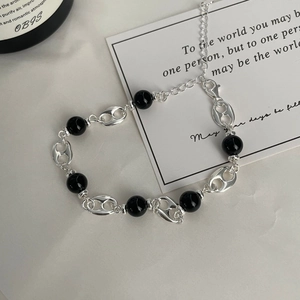 Detail of S925 silver bracelet featuring black agate beads and pig nose links