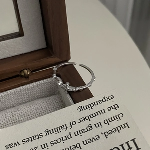 Macro view of S925 sterling silver cross ring with bamboo texture and white zircon