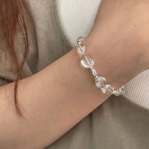 Detailed view of the clear crystal beaded bracelet with silver spacers on a wrist