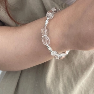 Detail shot of a minimalist S925 silver bracelet with irregular white crystals on a wrist