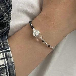 Détail d'un bracelet en argent S925 avec perles noires facettées et perles transparentes