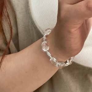 Close-up of minimalist S925 sterling silver beaded bracelet with clear crystal beads