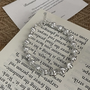 Macro shot of S925 sterling silver beaded bracelet with brushed texture and lobster clasp