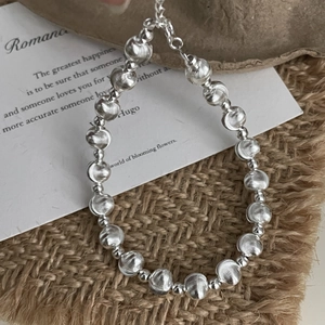 Detailed view of 925 sterling silver beads with fine striped texture and matte finish