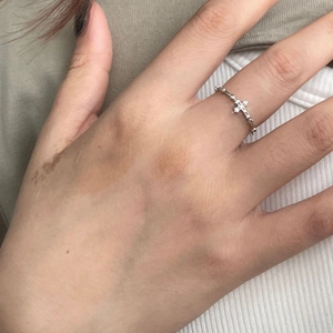 Detailed view of a slender S925 silver cross ring with pavé micro-inlaid zircon stones
