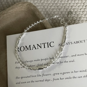 Macro view of S925 sterling silver bamboo bracelet with clear crystal beads and heart charm