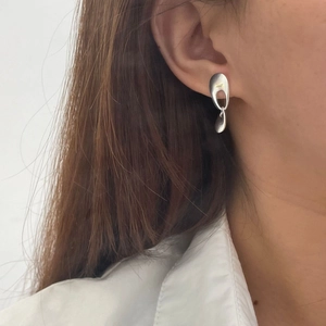Detail view of 925 silver minimalist geometric earrings on model for a modern look
