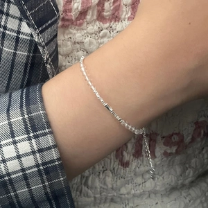 Macro shot of S925 sterling silver bamboo style beaded bracelet with clear crystal accents