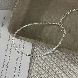 Detailed macro view of S925 silver bamboo-style bracelet with white crystal beads and lobster clasp
