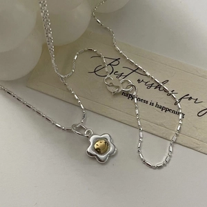 S925 Sterling silver sunflower necklace with a gold smiley face pendant on a gift card