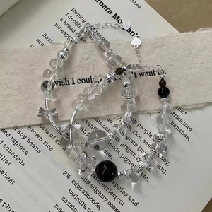 Close-up of S925 sterling silver beaded bracelet with quartz crystals and bow charm