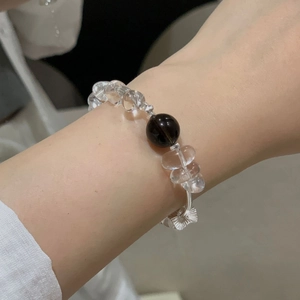 Detailed view of S925 silver beaded bracelet with clear quartz and smoky crystal on wrist