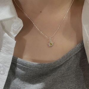 Minimalist S925 sterling silver sunflower necklace with yellow gemstone on model neck
